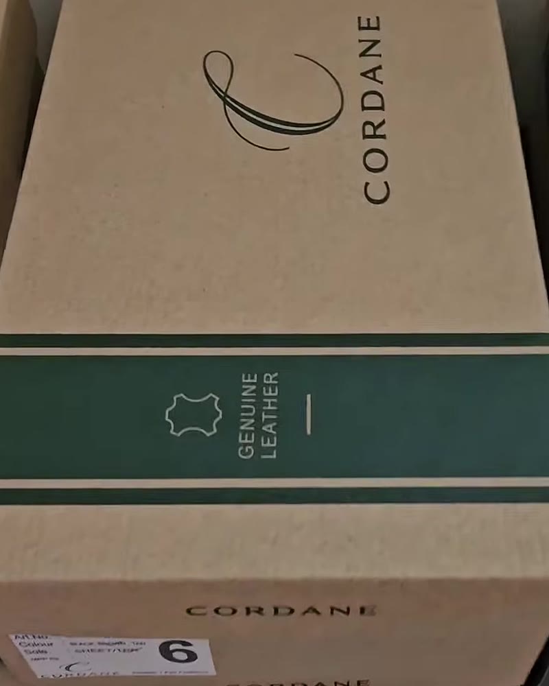 Kraft Cordane shoe box with the C monogram and a green Genuine Leather band
