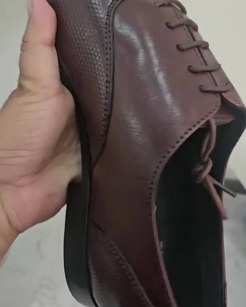Oxblood textured leather oxford in hand