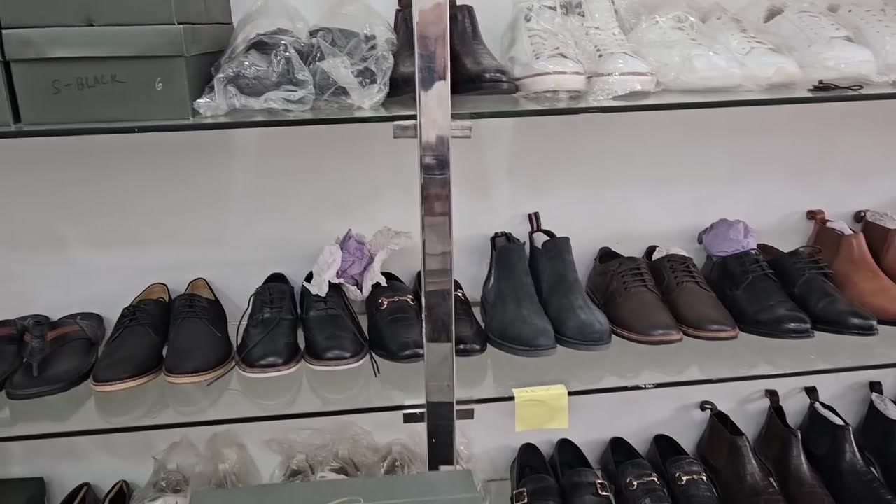 Showroom shelves lined with Cordane formal shoes, loafers and boots